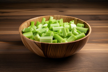 Cut green celery stem bowl on wooden table. Создать ИИ - yliv