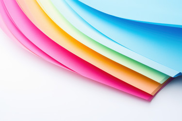 Bright colorful paper isolated on white table. Generate Ai - yliv