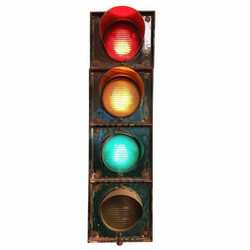 Grungy vintage traffic light showing all three colors, red, yellow and green, isolated on white background - yliv