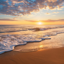 Golden sunrise illuminating sandy beach with gentle waves - yliv