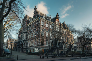 View of classic dutch architecture lining a street corner in amsterdam, netherlands - yliv