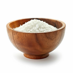 Wooden bowl overflowing with uncooked rice on white background - yliv