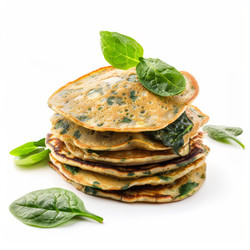 вкусные блинчики со шпинатом, выложенные высокой стопкой и украшенные свежими листьями шпината, создают полезный и привлекательный вариант завтрака - yliv