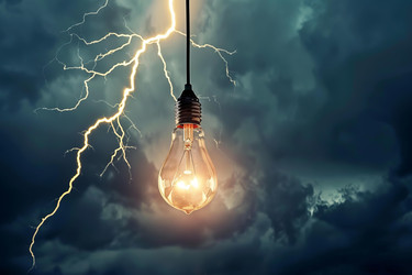 Light bulb shining during storm providing light in darkness - yliv