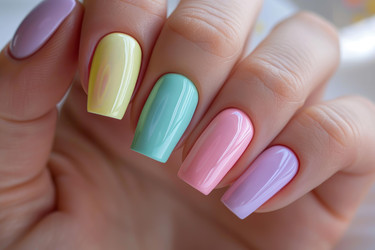 Woman showing colorful pastel nails manicure design - yliv