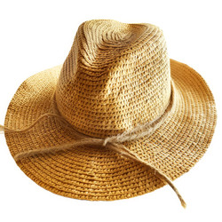 Yellow straw hat with ribbon lying on white background - yliv