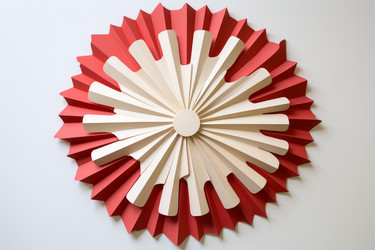 Intricate paper art in red and beige forming concentric circles with folded edges, creating a visually appealing design - yliv