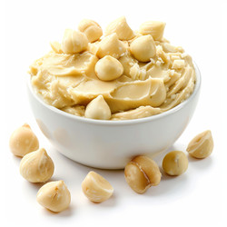 Macadamia nut butter decorated with macadamia nuts in a white bowl - yliv