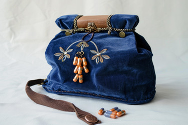 Blue velvet handmade bag with capsules representing healthcare and style - yliv