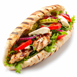 Delicious pita bread sandwich stuffed with grilled chicken and fresh vegetables - yliv