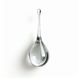 Transparent drop of water creating a perfect shape on white background - yliv