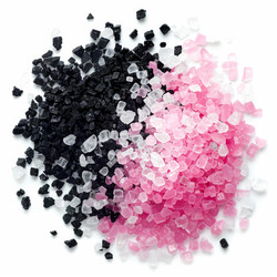 Pink, white and black hawaiian lava salt crystals creating colorful pattern - yliv
