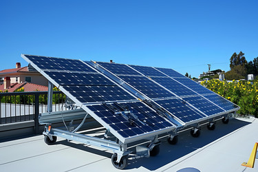 Solar panels installed on a flat roof are generating electricity on a sunny day - yliv