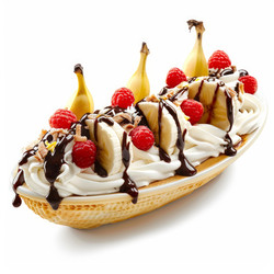 Banana split sundae drizzled with chocolate syrup and topped with raspberries and whipped cream - yliv