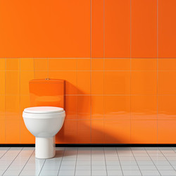 Modern white toilet in an orange bathroom with tiled walls and floor - yliv