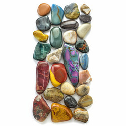 Colorful polished gemstones forming a vertical line on white background - yliv