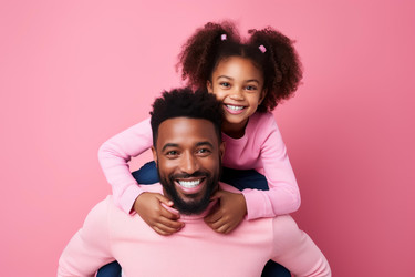 Happy father and daughter smiling together on pink background - yliv