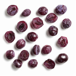 Freeze dried grapes showing seeds and skin on white background - yliv