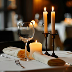 Romantic dinner table setting with burning candles and wine glass in restaurant - yliv