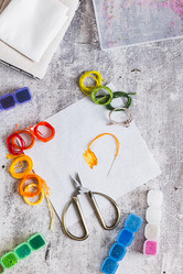 Cross-stitch—a trendy analog hobby—with a kit on the table top and vertical view - Elena Rui