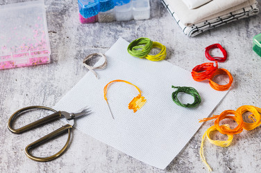 Cross-stitch—a trendy analog hobby—with a kit on the table - Elena Rui