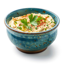 вкусный хумус, украшенный петрушкой, оливковым маслом и паприкой в голубой миске - yliv
