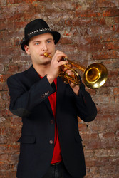 Young handsome man in suit and hat plays trumpet - paha_l