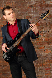 Young man in suit and red shirt plays guitar in - paha_l