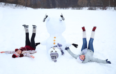 Upside down snowman with hat and two happy women - paha_l
