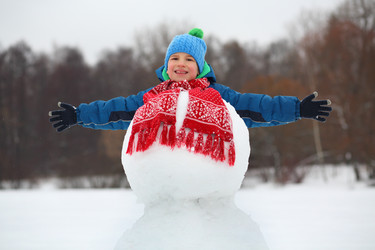 Happy boy in hat plays with snowman - with red - paha_l