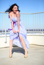 Pretty girl in dress stands on roof of tall - paha_l