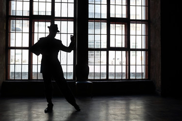 Silhouette of man in black suit and hat dancing - paha_l