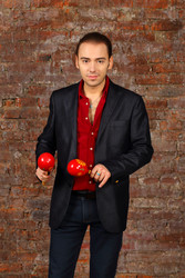 Handsome man in suit stands with red maracas in - paha_l