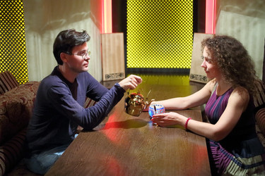 Man and woman sitting at a table in a cafe looking - paha_l