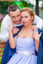 Woman in dress and jacket sits on bench and man - paha_l