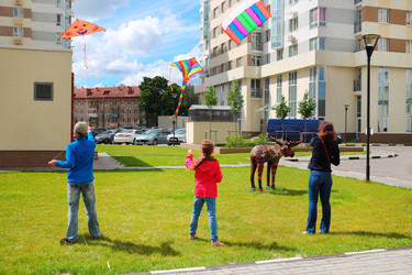 Mother with children launch kites on ground near - paha_l
