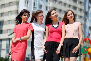 Four happy pretty girls pose outdoor on street at - paha_l