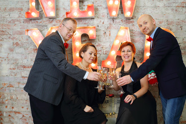Four happy friends clink glasses with white wine - paha_l