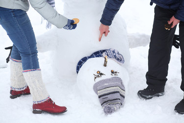 Hands of woman and man making inverted snowman at - paha_l