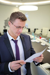 Portrait of businessman reading a document in the - paha_l