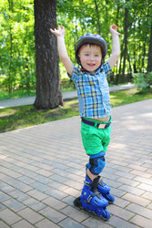 Little handsome boy in helmet roller skates in - paha_l
