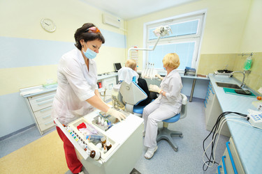 RUSSIA, MOSCOW - AUG 31, 2015: Dentist and his assistant preparing for - paha_l