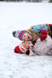 Mother and her cute little son lies on ice and - paha_l