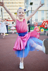 Little girl in dance suit dances at playground in - paha_l