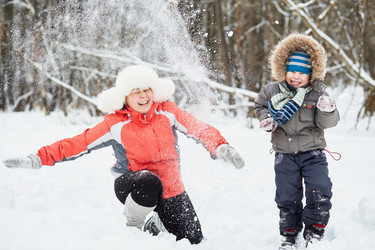 Mother and little son play throwing snow in winter - paha_l