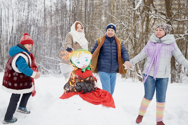 Family of four dance in a circle around burning - paha_l
