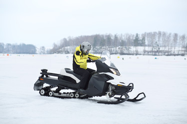 Man in helmet and yellow jacket riding a - paha_l