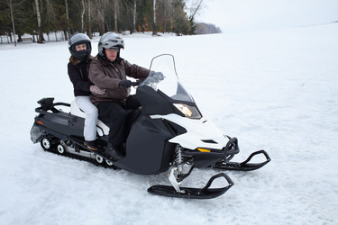 Father with young daughter riding on a snowmobile - paha_l