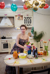Young woman prepares table at kitchen for birthday - paha_l