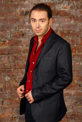 Young handsome man in suit and red shirt poses in - paha_l